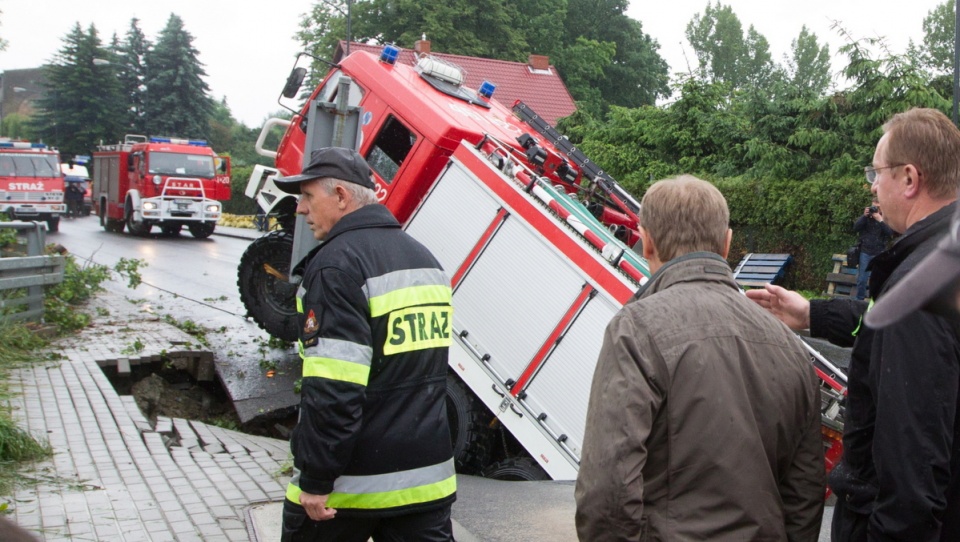 Jedna z podmytych dróg w Głuchołazach zapadła się, a wraz z nią jadący do akcji wóz strażacki. Fot. PAP/ Andrzej Grygiel
