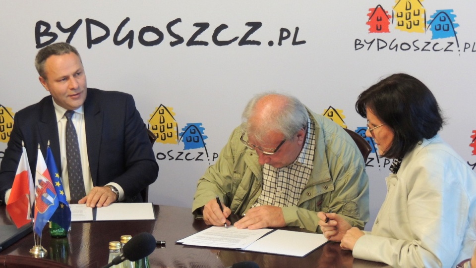 Prezydent Rafał Bruski podpisuje umowę z przedstawicielami dwóch ogrodów działkowych. Fot. Damian Klich